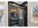 Chic bathroom with modern black marble shower, vanity and fixtures, and a window at 2418 Crossroads Ave, Hillsborough, NC 27278