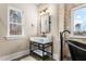 Bathroom with stone accent wall, black freestanding tub, and modern sink with vanity at 2418 Crossroads Ave, Hillsborough, NC 27278