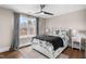 Bright bedroom featuring a ceiling fan and large window showcasing the natural outdoor view at 2418 Crossroads Ave, Hillsborough, NC 27278