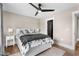 Cozy bedroom featuring a ceiling fan with a door leading to a bathroom at 2418 Crossroads Ave, Hillsborough, NC 27278