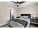 Relaxing bedroom with a ceiling fan, warm lighting and door that leads to the bathroom at 2418 Crossroads Ave, Hillsborough, NC 27278