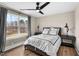 Well-lit bedroom features a ceiling fan, a large window, and modern furnishings at 2418 Crossroads Ave, Hillsborough, NC 27278