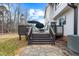 Multi-level wooden deck with stairs leading to the backyard and outdoor seating area at 2418 Crossroads Ave, Hillsborough, NC 27278