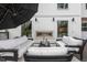 Comfortable outdoor deck with an outdoor fireplace and umbrella shaded seating area at 2418 Crossroads Ave, Hillsborough, NC 27278