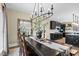 Open dining room area with an elegant mirror and a view to a modern, eat-in kitchen at 2418 Crossroads Ave, Hillsborough, NC 27278