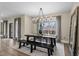 Bright dining room with views of the backyard and features a rustic table with dark wood at 2418 Crossroads Ave, Hillsborough, NC 27278