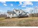 Back exterior view of the home featuring a deck and white siding at 2418 Crossroads Ave, Hillsborough, NC 27278