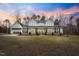 Beautiful two-story home featuring a classic white facade and an inviting covered front porch at 2418 Crossroads Ave, Hillsborough, NC 27278