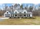 Charming two-story modern farmhouse with black framed windows, metal roof, and an attached garage at 2418 Crossroads Ave, Hillsborough, NC 27278