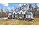 Charming two-story modern farmhouse with black framed windows, metal roof, and an attached garage at 2418 Crossroads Ave, Hillsborough, NC 27278