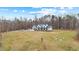 Stunning two-story modern farmhouse with a metal roof and a spacious lawn at 2418 Crossroads Ave, Hillsborough, NC 27278