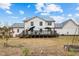 Rear exterior showcasing a spacious deck, white siding, and dark metal roof at 2418 Crossroads Ave, Hillsborough, NC 27278