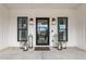 Welcoming front entrance adorned with decorative lanterns, a modern door, and symmetrical windows at 2418 Crossroads Ave, Hillsborough, NC 27278