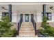 Charming brick staircase leading to the front entrance, accented with manicured greenery at 2418 Crossroads Ave, Hillsborough, NC 27278