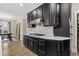 Stylish kitchen featuring gas range, decorative backsplash, and sleek, dark cabinetry at 2418 Crossroads Ave, Hillsborough, NC 27278