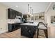 Spacious kitchen with dark cabinetry, quartz countertops, and a large island with seating at 2418 Crossroads Ave, Hillsborough, NC 27278
