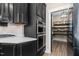 Modern kitchen with built-in stainless steel double ovens and a view into the walk-in pantry at 2418 Crossroads Ave, Hillsborough, NC 27278