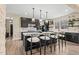 Spacious kitchen featuring a large island with seating, lots of cabinet space, and views from the window at 2418 Crossroads Ave, Hillsborough, NC 27278
