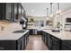 Modern kitchen with black cabinets, stainless steel appliances, a gas stovetop, and bright countertops at 2418 Crossroads Ave, Hillsborough, NC 27278