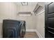 Convenient laundry room with modern washer and dryer set and white storage shelves at 2418 Crossroads Ave, Hillsborough, NC 27278