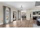 Open-concept living space with hardwood floors, large windows, and easy access to the outdoor living area at 2418 Crossroads Ave, Hillsborough, NC 27278