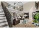 Spacious living room with high ceilings, stone accent wall, leather furniture, and an open concept design at 2418 Crossroads Ave, Hillsborough, NC 27278