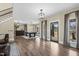 Open-concept living room with a pool table, neutral walls, lots of windows, stylish light fixtures and sleek flooring at 2418 Crossroads Ave, Hillsborough, NC 27278