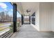 Inviting covered porch with a porch swing and ceiling fan on a charming farmhouse at 2418 Crossroads Ave, Hillsborough, NC 27278