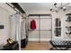 Walk-in closet with custom metal pipe shelving and a stylish black bench at 2418 Crossroads Ave, Hillsborough, NC 27278