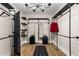 Spacious walk-in closet with custom black metal pipe shelving, bench, and chandelier at 2418 Crossroads Ave, Hillsborough, NC 27278