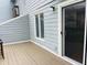 Private back patio with wood flooring is perfect for outdoor dining and relaxation at 250 S Estes S Dr # Apt 113, Chapel Hill, NC 27514