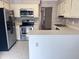 Bright kitchen with stainless steel appliances, white cabinets, and tile floors at 250 S Estes S Dr # Apt 113, Chapel Hill, NC 27514