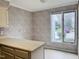 Cozy kitchen with breakfast bar area and large window, wallpaper and tile flooring at 250 S Estes S Dr # Apt 113, Chapel Hill, NC 27514