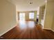 Spacious living room with hardwood floors, fireplace, and sliding glass doors to the patio at 250 S Estes S Dr # Apt 113, Chapel Hill, NC 27514