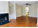 Well-lit living room with hardwood floors, fireplace, and built-in shelving at 250 S Estes S Dr # Apt 113, Chapel Hill, NC 27514