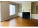 Bright living room features hardwood floors, built-in shelving, and a cozy fireplace, great for entertaining at 250 S Estes S Dr # Apt 113, Chapel Hill, NC 27514