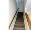 Carpeted staircase with wooden handrail leading to the upper level of the home at 250 S Estes S Dr # Apt 113, Chapel Hill, NC 27514