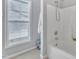 Bathroom with white tile and tub with shower head at 2520 Friedland Pl # 102, Raleigh, NC 27617