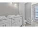Bright bathroom features a double sink vanity and a glass enclosed shower at 2520 Friedland Pl # 102, Raleigh, NC 27617