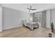 Light-filled bedroom features a ceiling fan and curtains with a view to the outdoors at 2520 Friedland Pl # 102, Raleigh, NC 27617