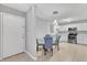 Inviting dining area with a glass table set and a view of the fully-equipped modern kitchen at 2520 Friedland Pl # 102, Raleigh, NC 27617