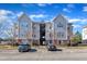 Attractive apartment complex with assigned parking spaces and well-maintained landscaping under a bright, partly cloudy sky at 2520 Friedland Pl # 102, Raleigh, NC 27617