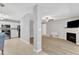 Open-concept living area with modern fireplace, seamlessly connected to the dining and kitchen spaces at 2520 Friedland Pl # 102, Raleigh, NC 27617