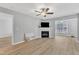 Bright living room featuring a stylish fireplace and large windows, creating a comfortable living space at 2520 Friedland Pl # 102, Raleigh, NC 27617
