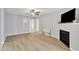 Bright living room featuring a fireplace, ceiling fan, and wood-look flooring at 2520 Friedland Pl # 102, Raleigh, NC 27617
