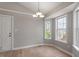 Well-lit dining room with hardwood floors and great natural light from large windows at 262 Tillamook Dr, Wake Forest, NC 27587