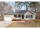 Charming single-story home with gray siding, a covered front porch, and an attached one-car garage at 262 Tillamook Dr, Wake Forest, NC 27587