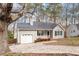Traditional one-story home featuring an attached garage, front porch, and mature landscaping, offering curb appeal at 262 Tillamook Dr, Wake Forest, NC 27587