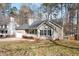 Exterior view of a quaint home with an attached garage, nestled amongst the trees in a quiet neighborhood at 262 Tillamook Dr, Wake Forest, NC 27587