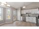 Well-lit kitchen with stainless steel appliances, granite countertops, and bright white cabinets at 262 Tillamook Dr, Wake Forest, NC 27587